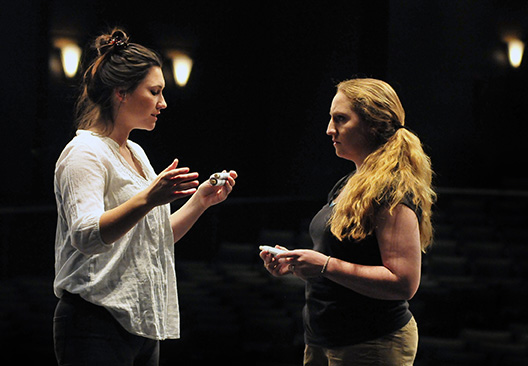 Two actors with scrolls